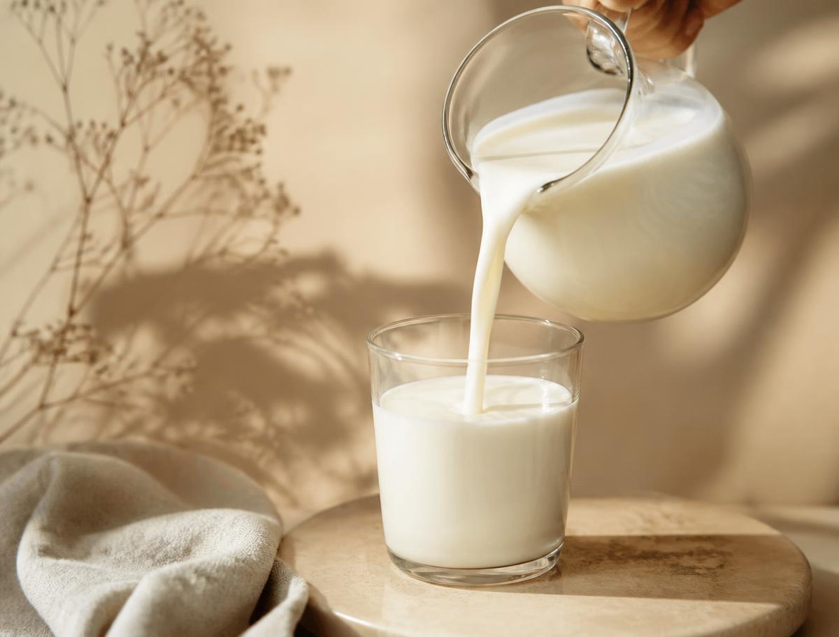 Rich organic buffalo milk being poured into a glass